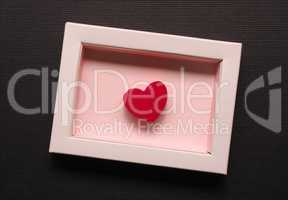 Red wooden heart shape in a gift box