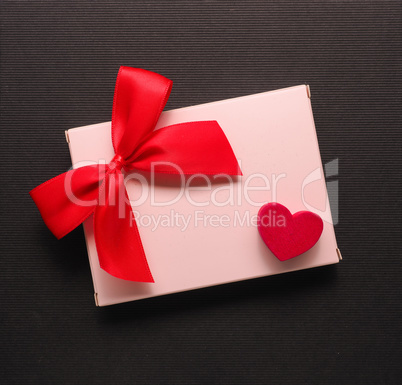 Red wooden heart shape on a gift box