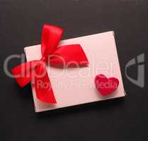 Red wooden heart shape on a gift box