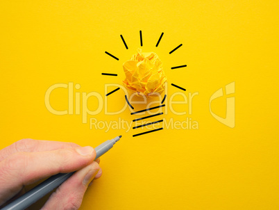 Yellow crumpled paperball as lightbulb