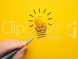 Yellow crumpled paperball as lightbulb