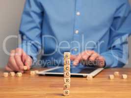 Concepual success business image with small wooden blocks