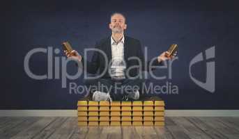Relaxed businessman sits on a stack of gold bars