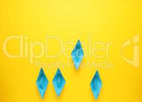 teamwork business concept with paper boat on yellow background