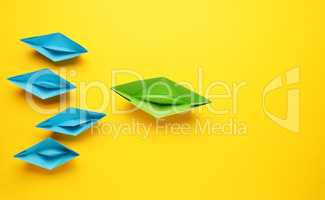 teamwork business concept with paper boat on yellow background