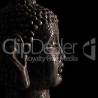 Buddha statue close up on a black background