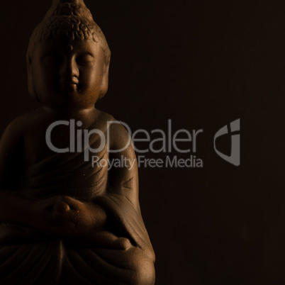 Buddha statue close up on a black background