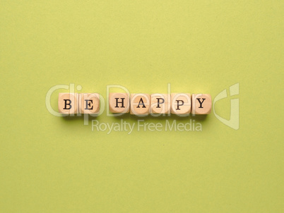 Be happy written with small wooden blocks