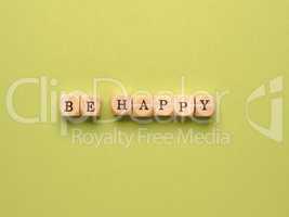 Be happy written with small wooden blocks