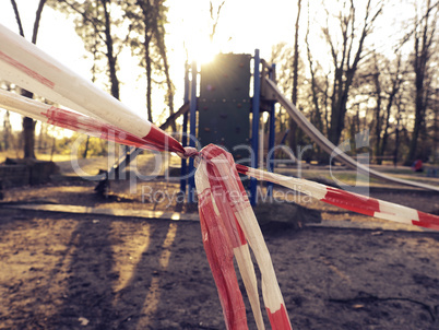 Close-up of the barrier tape in front of a playground