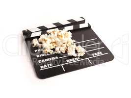 Clapper board with popcorn on white