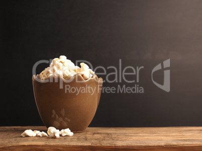Egg-shaped vase filled with popcorn against a dark blackboard