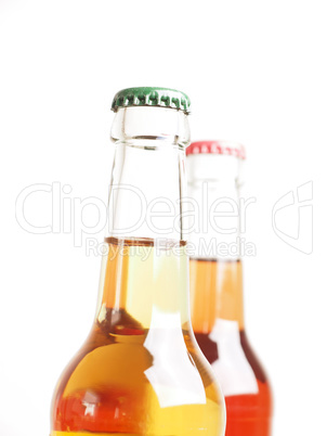 Two ice-cold bottles with organic lemonade against a white backg