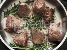 Organic beef fillet with rosemary and thyme in a stainless steel