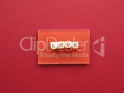 Wooden blocks with the word love on a red background