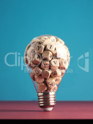 A lot of alphabetically labeled wooden cubes in a light bulb