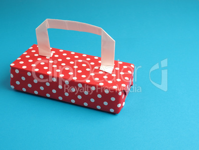 Dotted gift with a handle on a blue background