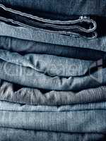 Stacked blue jeans using as background
