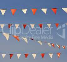 String of christmas flags or garland isolated on sky photo
