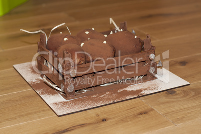Brown chokolate sweet potato cake on a wooden dark background. Fudge nuggets with cream photo