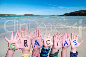 Children Hands Building Word Gracias Means Thank You, Ocean Background