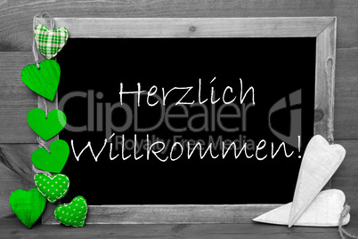 Balckboard With Green Heart Decoration, Text Herzlich Willkommen Means Welcome