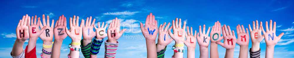 Children Hands Building Word Herzlich Willkommen Means Welcome, Blue Sky