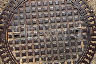 Old rusty metal street sewer drain cover top hatch texture