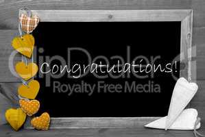 Balckboard With Yellow Heart Decoration, Text Congratulations, Gray Wooden Background