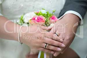 The hands of a newlyweds with the wedding rings