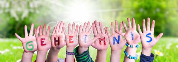 Children Hands Building Word Geheimnis Means Secret, Grass Meadow