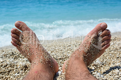 Beach relaxation on warm pebble