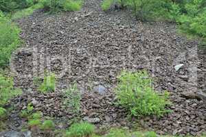 Stone landslide under spring rain, horizontal orientation