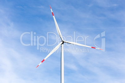 A windmill with a blue sky in the background