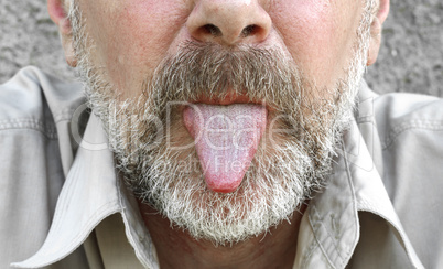 Part of a bearded face with tongue