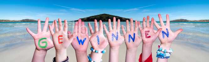 Children Hands Building Word Gewinnen Means Win, Ocean Background