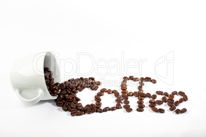 White cup with coffee beans on white background