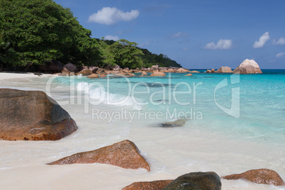 Seychelles with a turqouise water and big stones and lot of gree