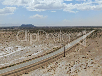 Aerial view of endless desert straight dusty asphalt road in Joshua Tree Park. USA.