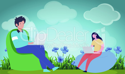 boy and girl sitting in a garden working on laptop