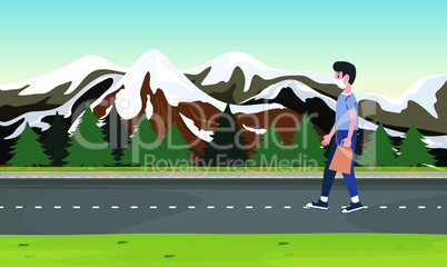 boy walking on the road near the mountains