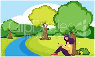 girl sitting near to the river and using phone