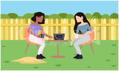girls are talking to each while sitting in a garden