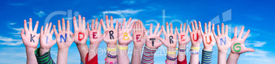 Kids Hands Holding Word Kinderbetreuung Means Child Day Care, Blue Sky