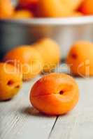 Mellow apricots over light wooden surface