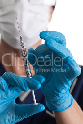 Doctor or Nurse Holding Medical Syringe with Needle