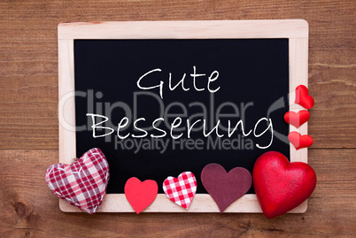 Balckboard With Red Heart Decoration, Text Gute Besserung Means Get Well Soon