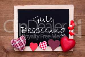 Balckboard With Red Heart Decoration, Text Gute Besserung Means Get Well Soon
