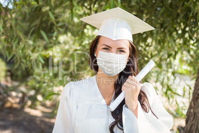 Female Graduate in Cap and Gown Wearing Medical Face Mask