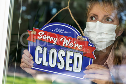 Female Store Owner Wearing Medical Face Mask Turning Sign to Clo